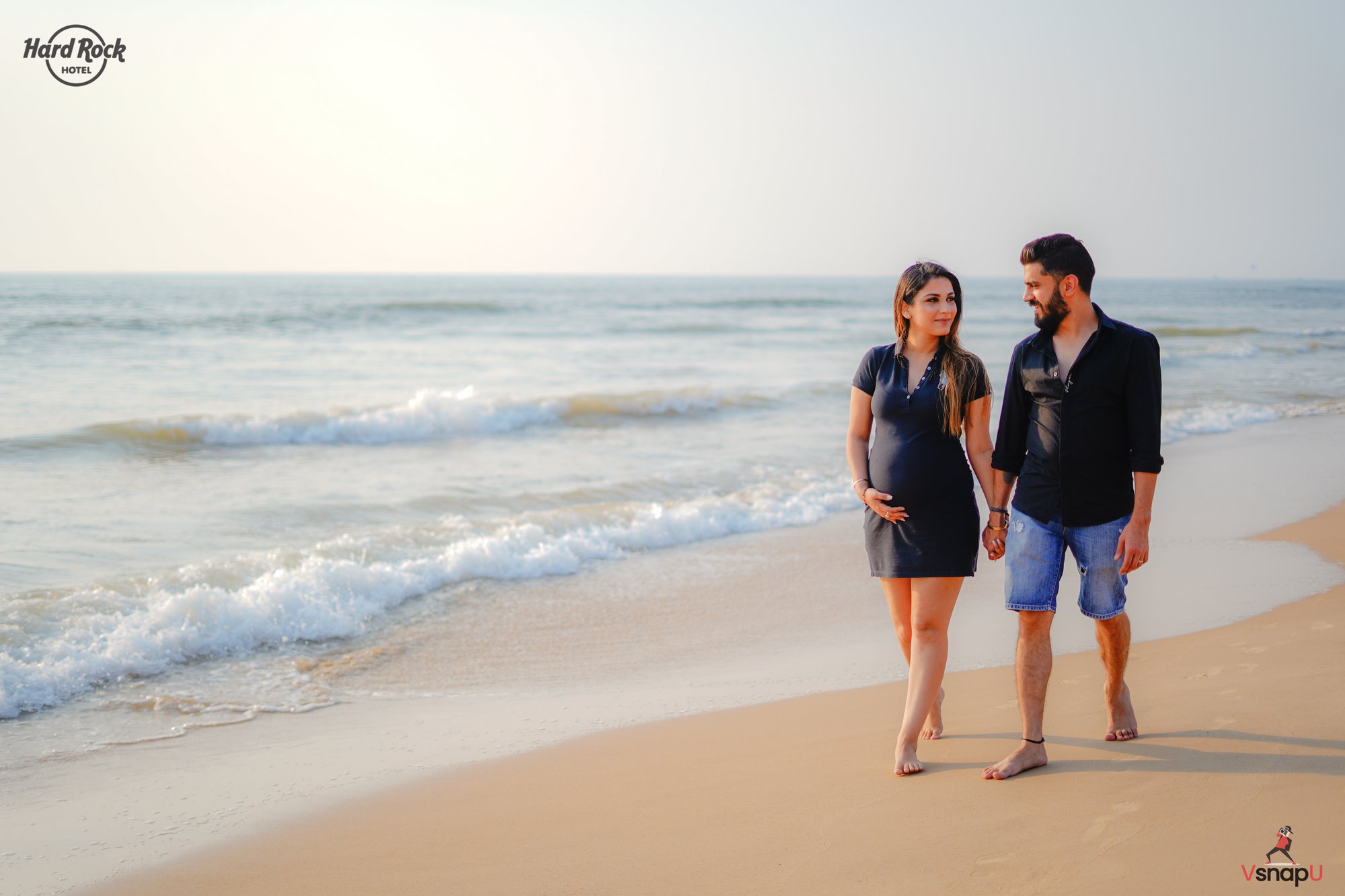 A mesmerizing maternity moment of an expecting couple, soaking in the beauty of the beach.